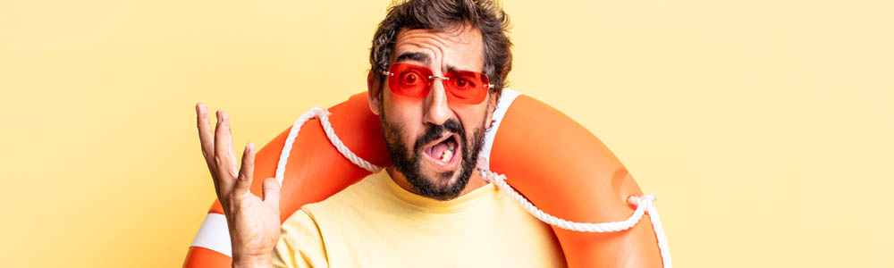 Young, strange man with a swimming ring around his body, making a weird face, on a yellow background